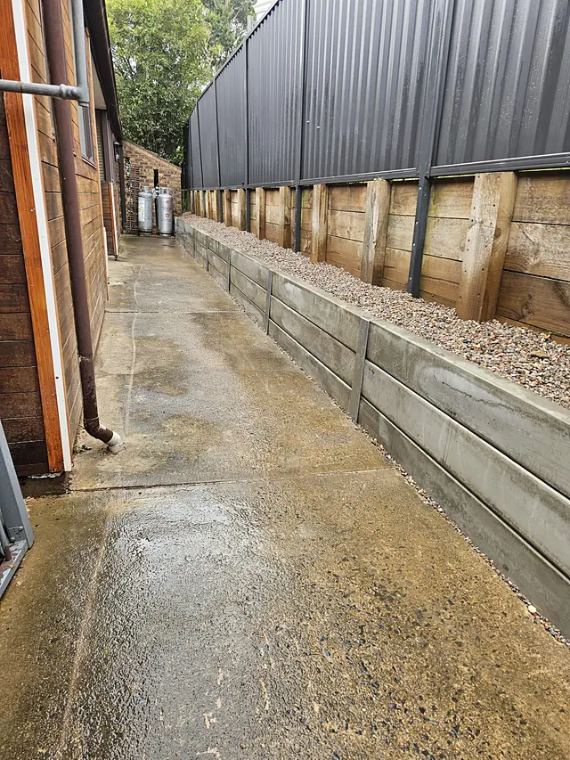 Concrete path with a sleeper retaining wall