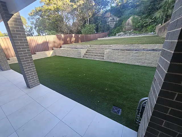 Terraced block walls, synthetic turf and tiled alfresco