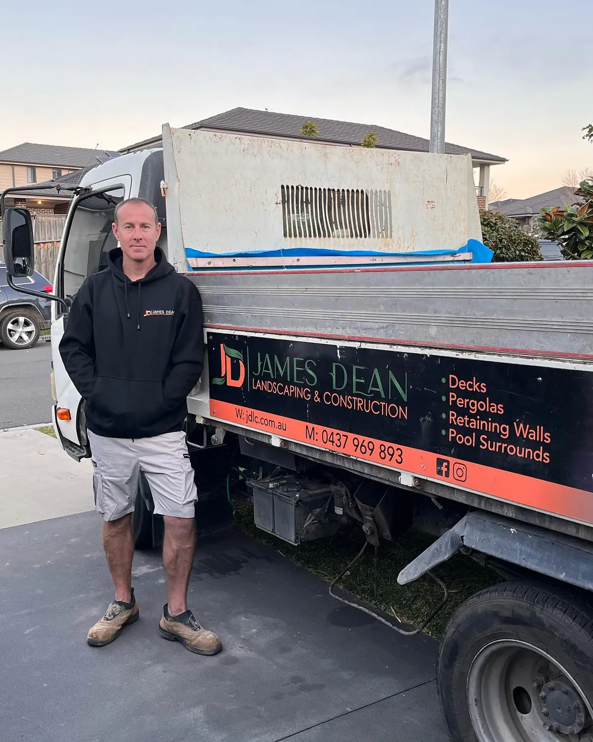 James Dean standing beside his signwritten James Dean Landscaping & Construction tipper